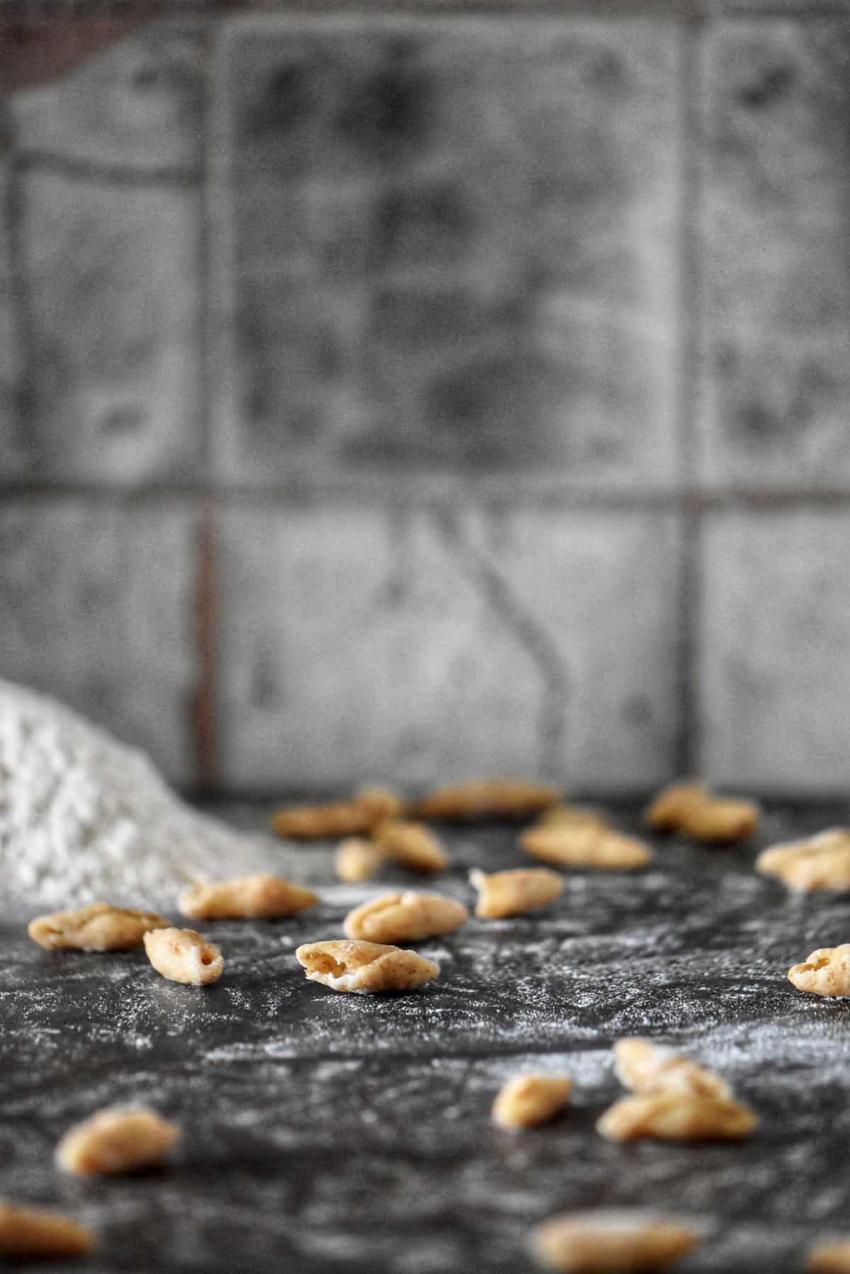 Whole wheat cavatelli on a floured surface.