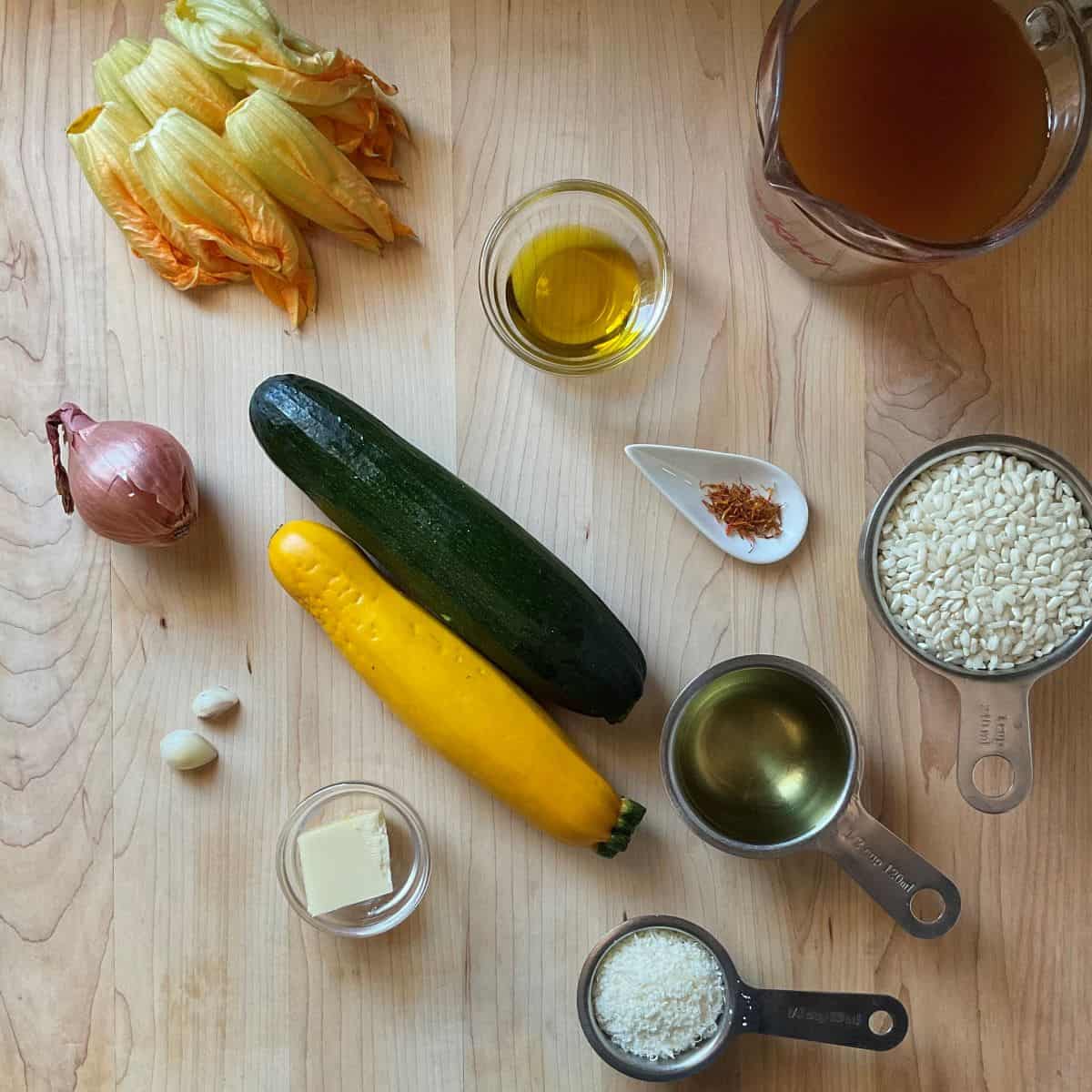 Ingredients to make zucchini risotto on a wooden board.