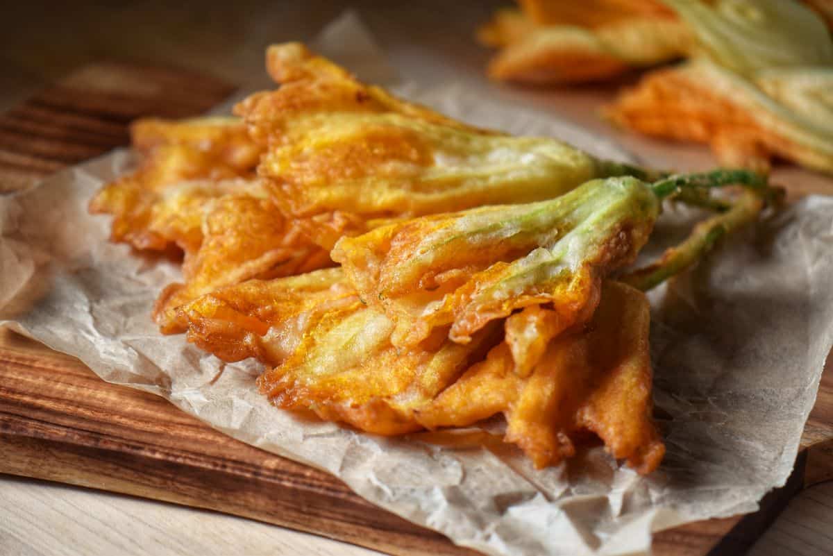 Fried squash blossoms on parchment paper.