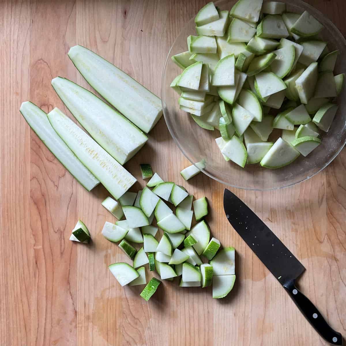 Sliced zucchini on a wooden board.