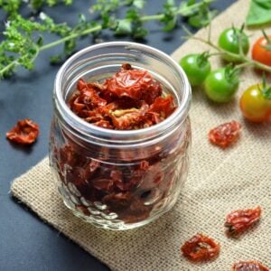 Dried cherry tomatoes in a Mason jar.