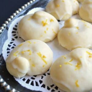 Glazed lemon knot cookies on a platter.