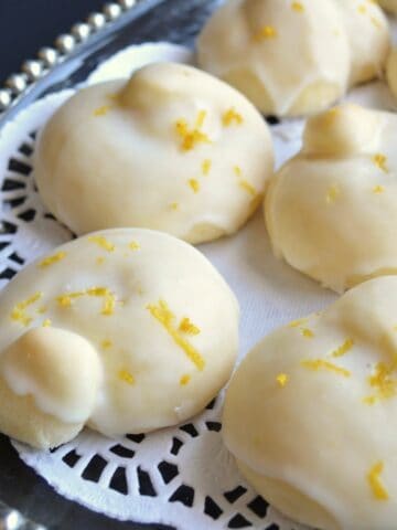 Glazed lemon knot cookies on a platter.