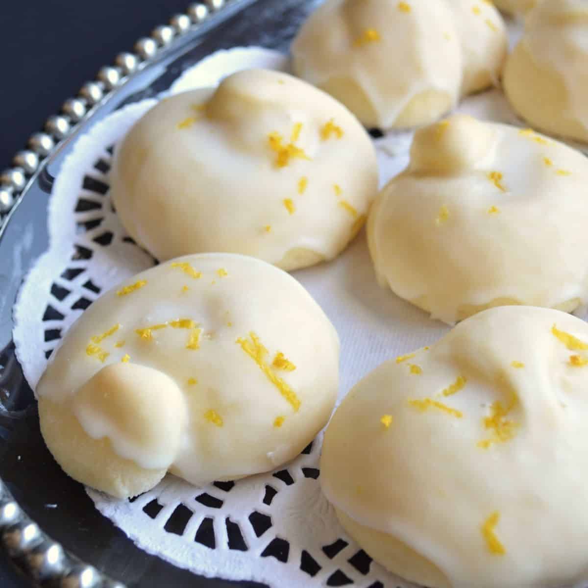Glazed lemon knot cookies on a platter.