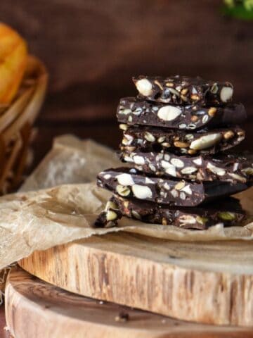 Chocolate bark with almonds on parchment paper.