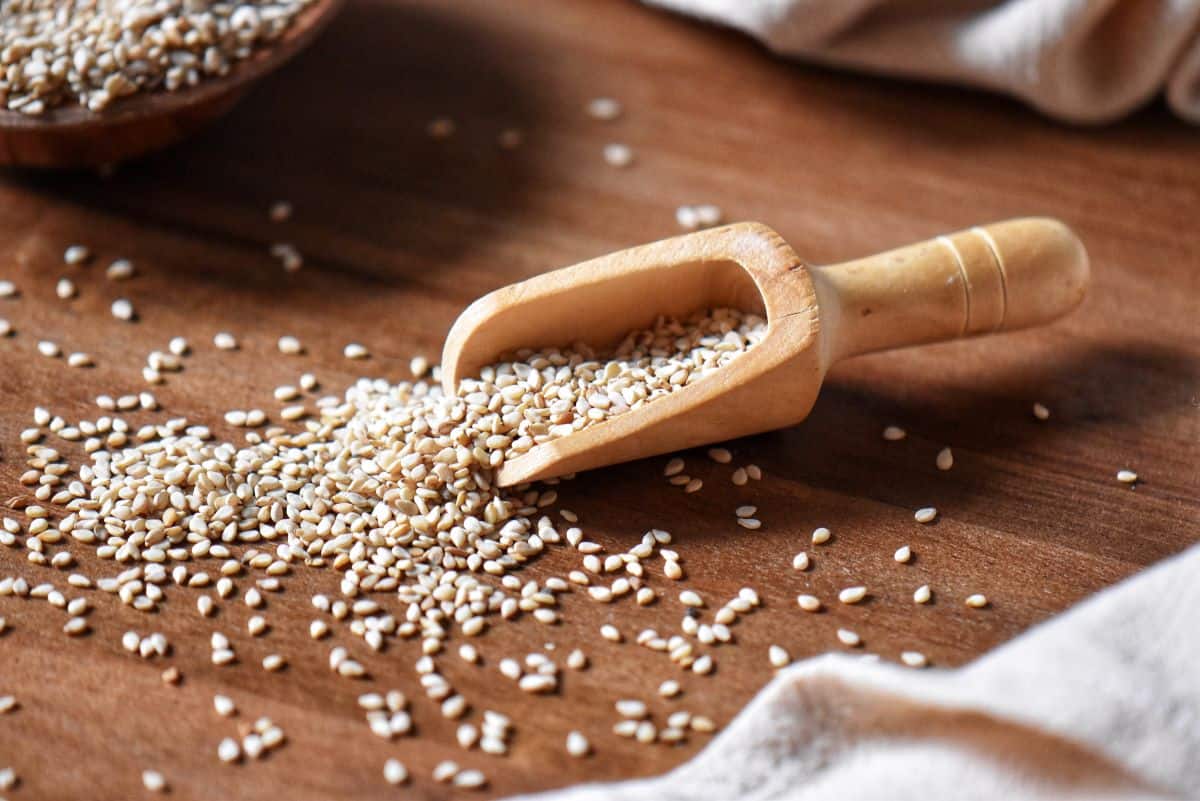 Sesame seeds on a wooden surface.
