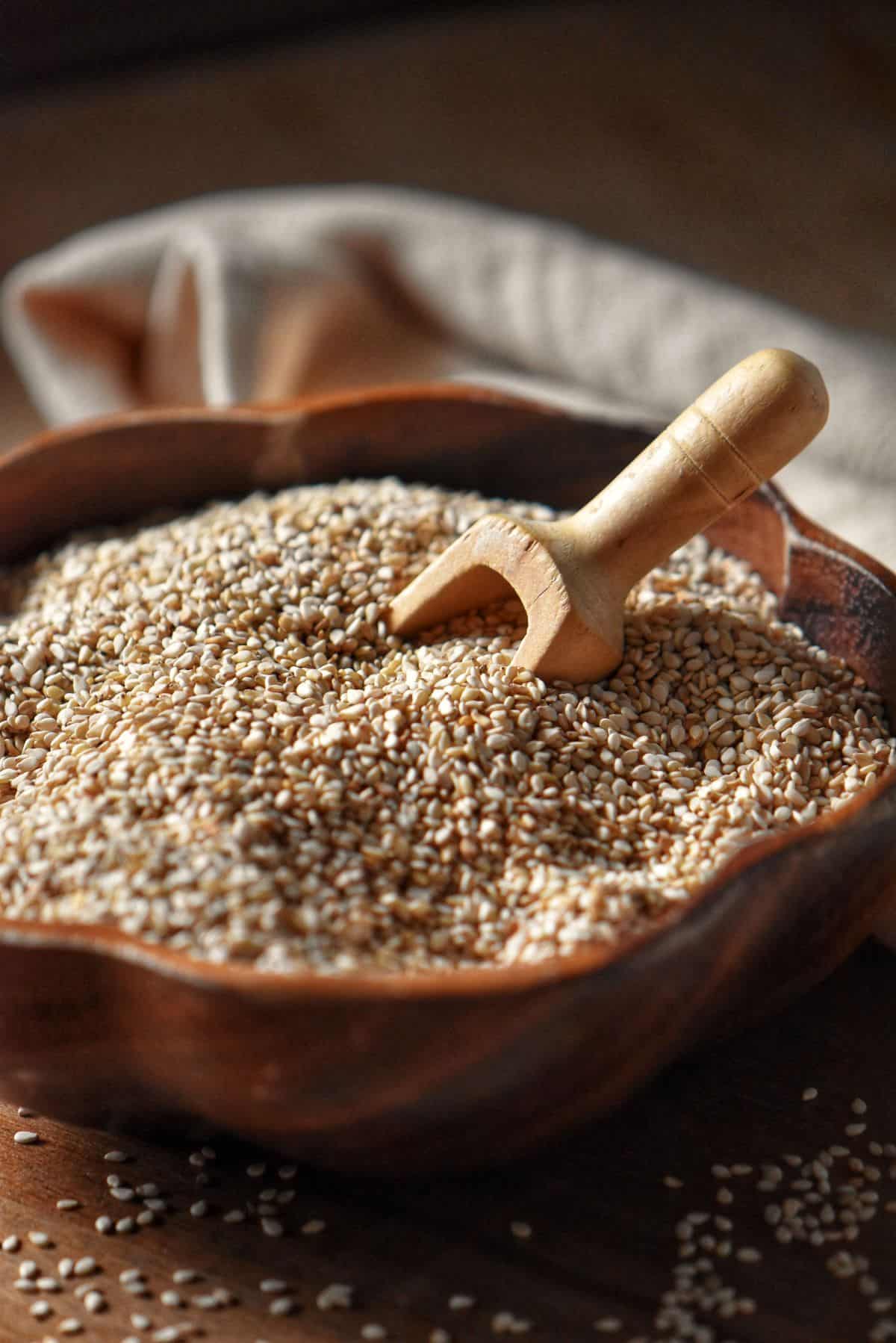 Toasted sesame seeds in a wooden bowl.