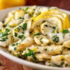 Baccalà Salad with parsley and slices of lemon.