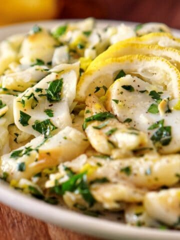 Baccalà Salad with parsley and slices of lemon.