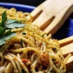 Pasta with breadcrumbs in a blue bowl.