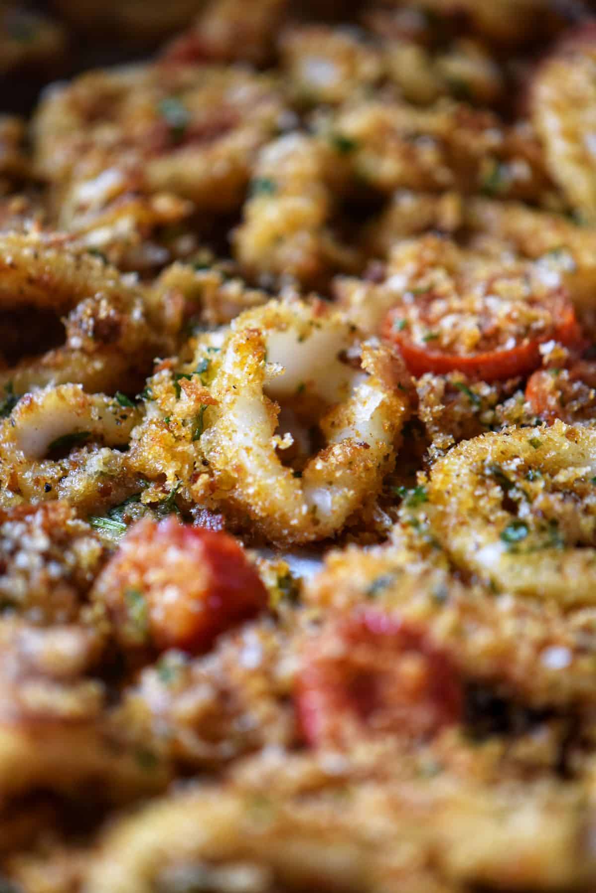 Baked calamari with homemade breadcrumbs and cherry tomatoes.