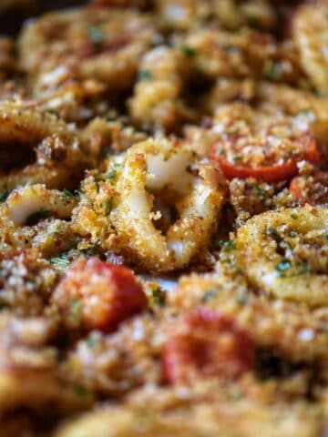 Baked calamari with breadcrumbs and cherry tomatoes.