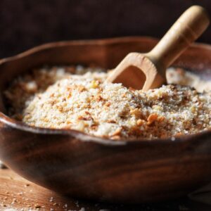 Freshly grated breadcrumbs in a wooden bowl.