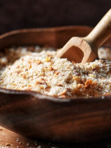 Freshly grated breadcrumbs in a wooden bowl.