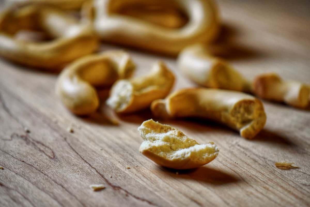 Crumbled taralli on a wooden board.