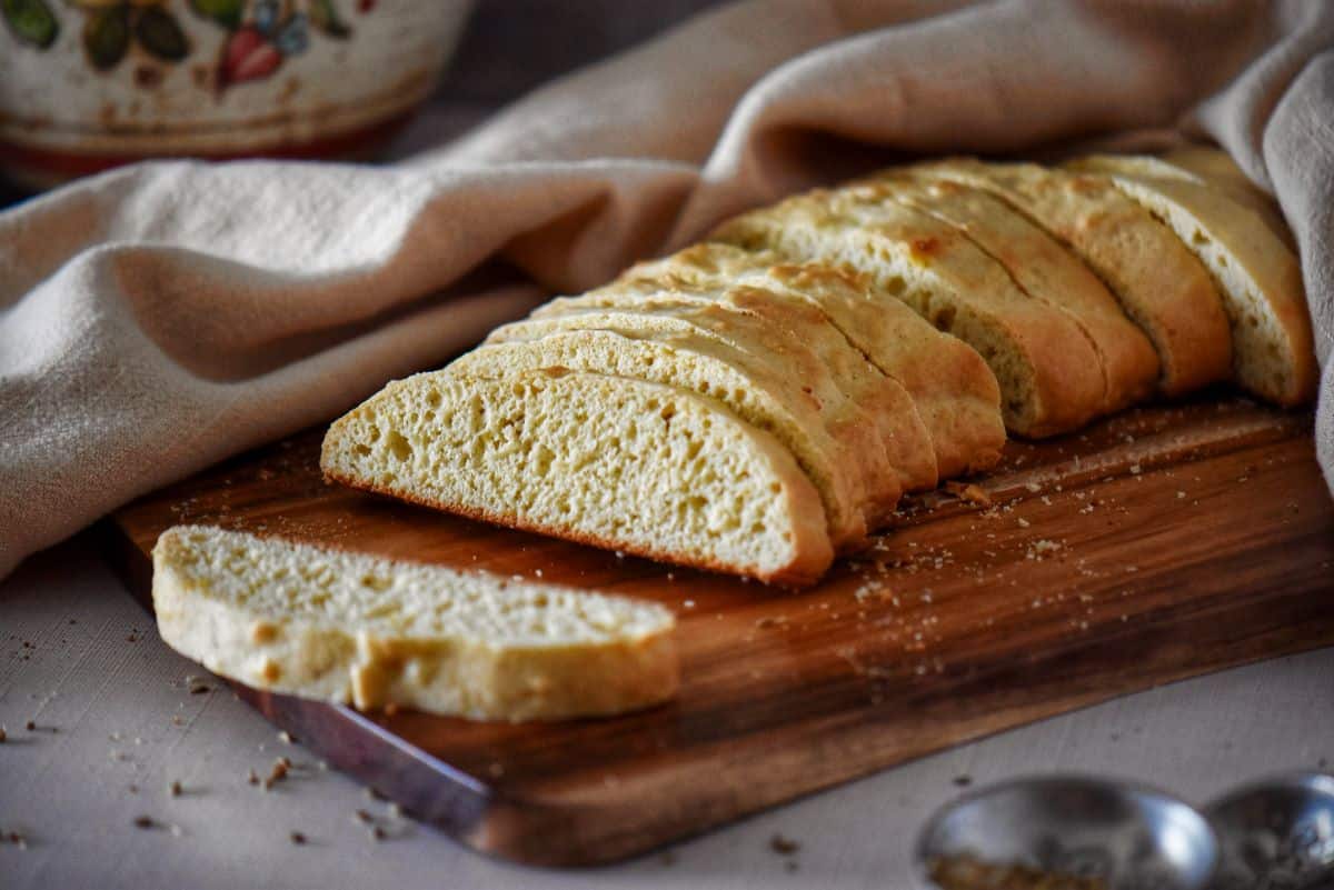 Sliced Italian sponge cookies on a cutting board.