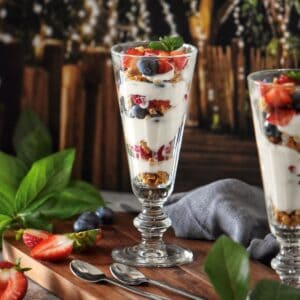 A fruit parfait with whipped ricotta in a parfait glass.