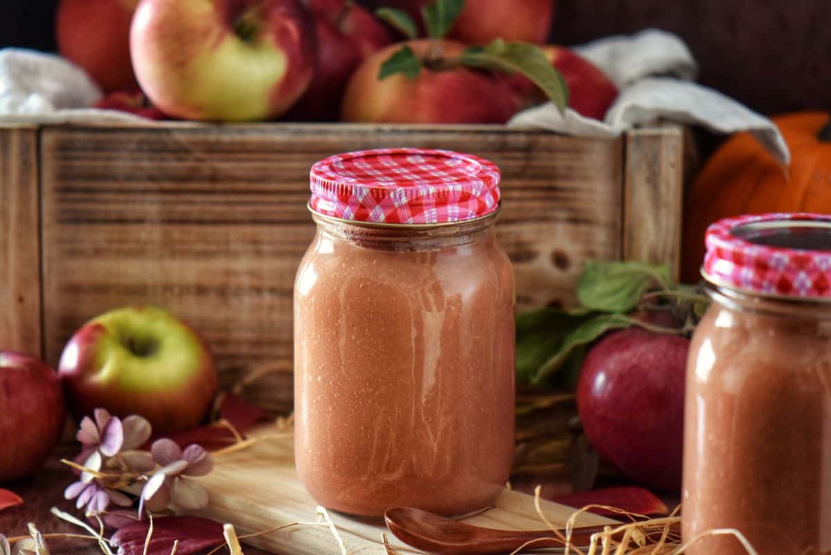 Freshly made slow cooker applesauce stored in a Mason jar for easy storage.