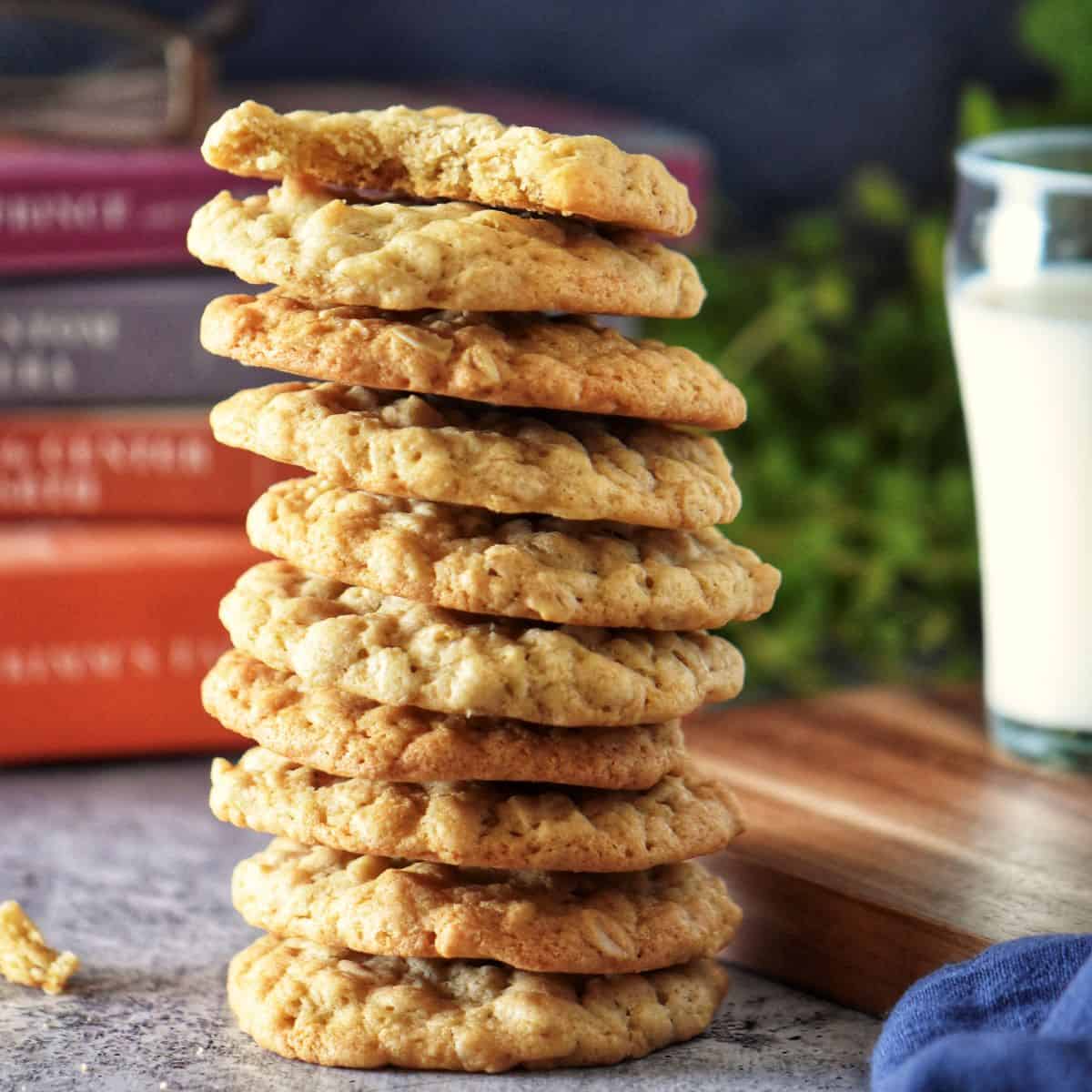 Stack of golden, chewy dairy-free oatmeal cookies, highlighting their soft texture and slightly crispy edges.