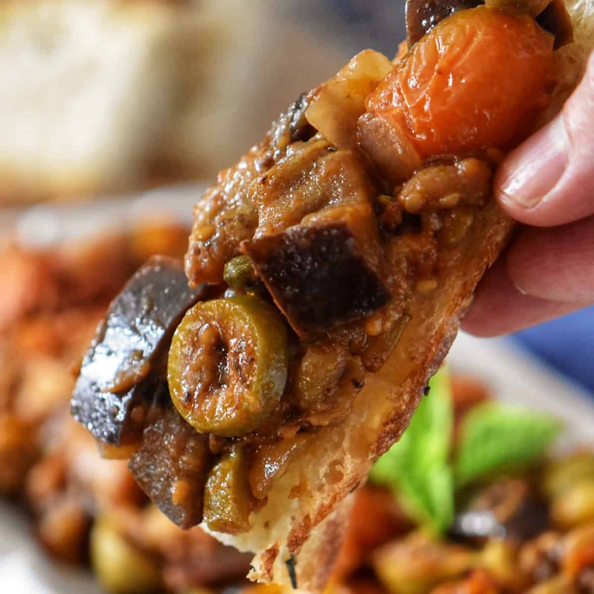 Eggplant caponata on a slice of focaccia bread.