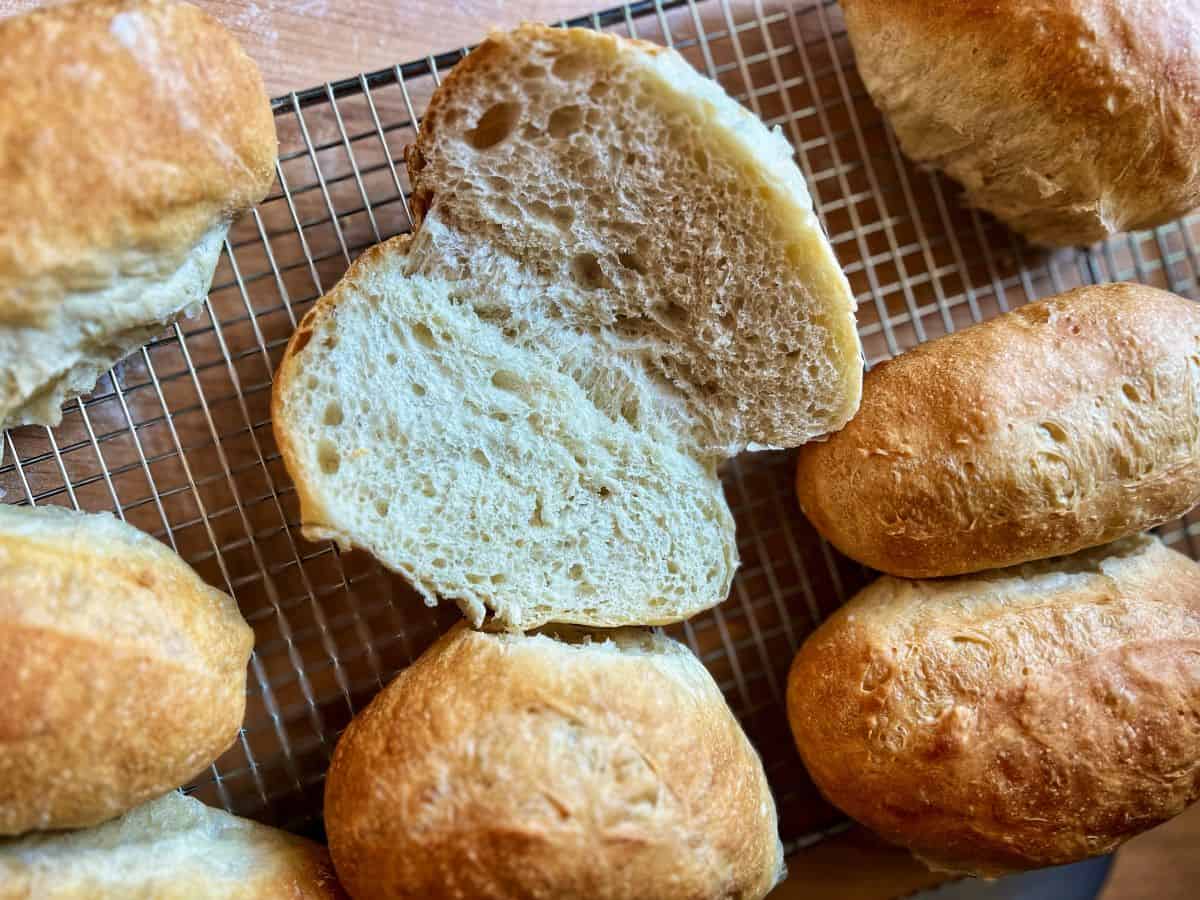 Sliced panini bread on a cooling rack.
