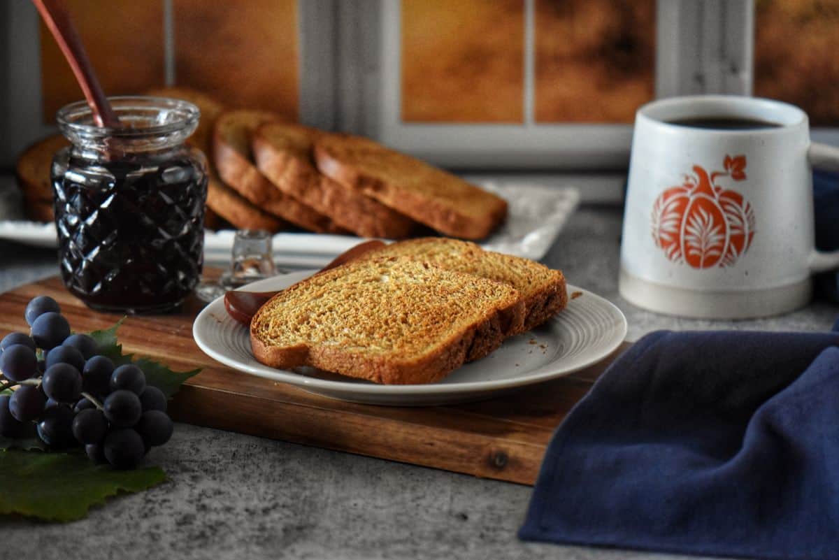Crisp fette biscottate (Italian breakfast toast) stacked on a white plate, ready to serve with coffee.