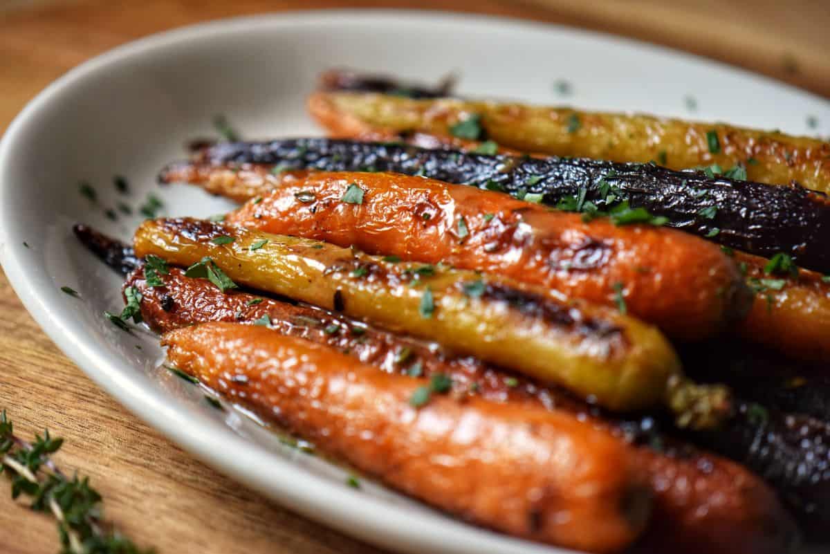Oven-roasted rainbow carrots on a white serving platter.
