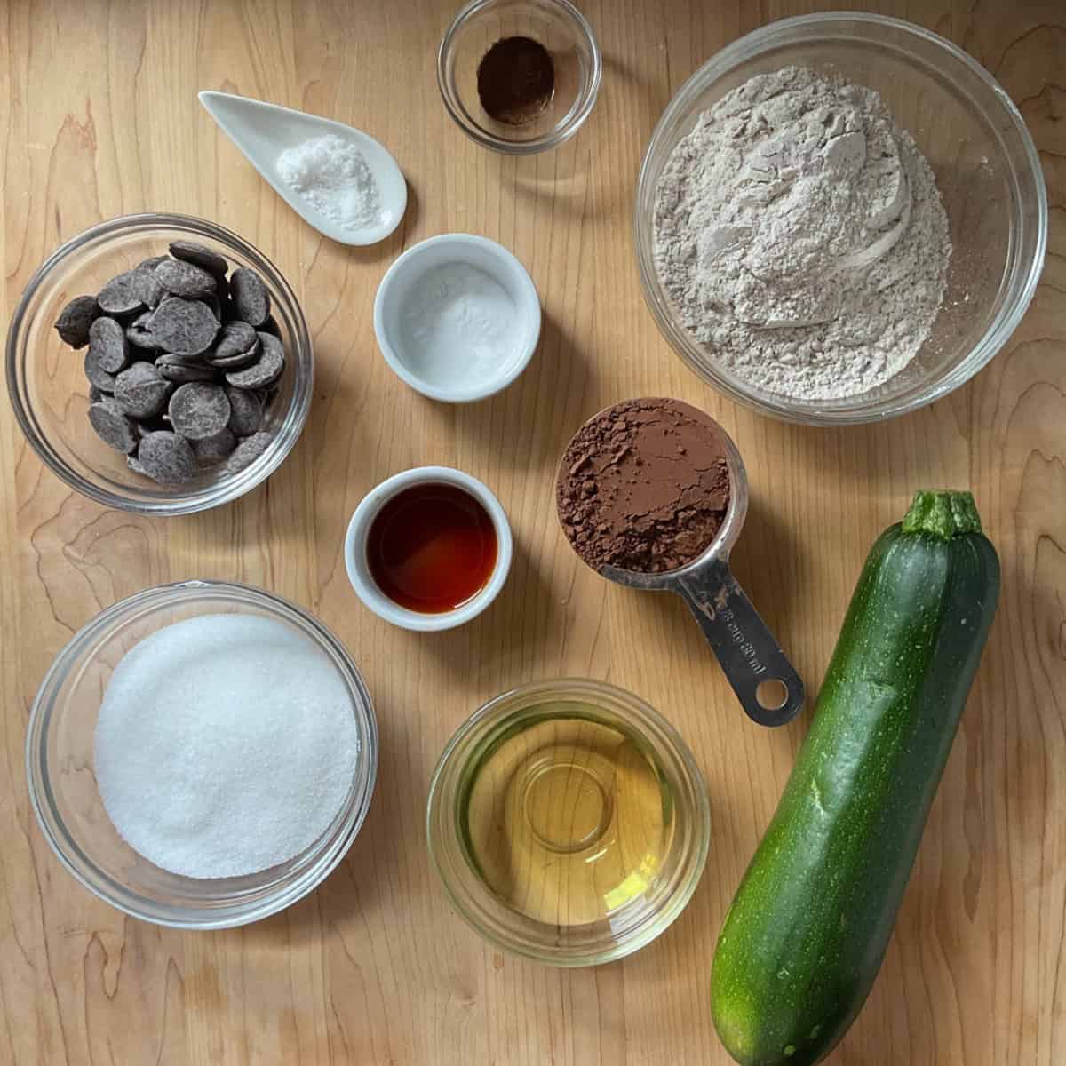 Flat lay of dry and wet ingredients prepared for chocolate zucchini brownies.