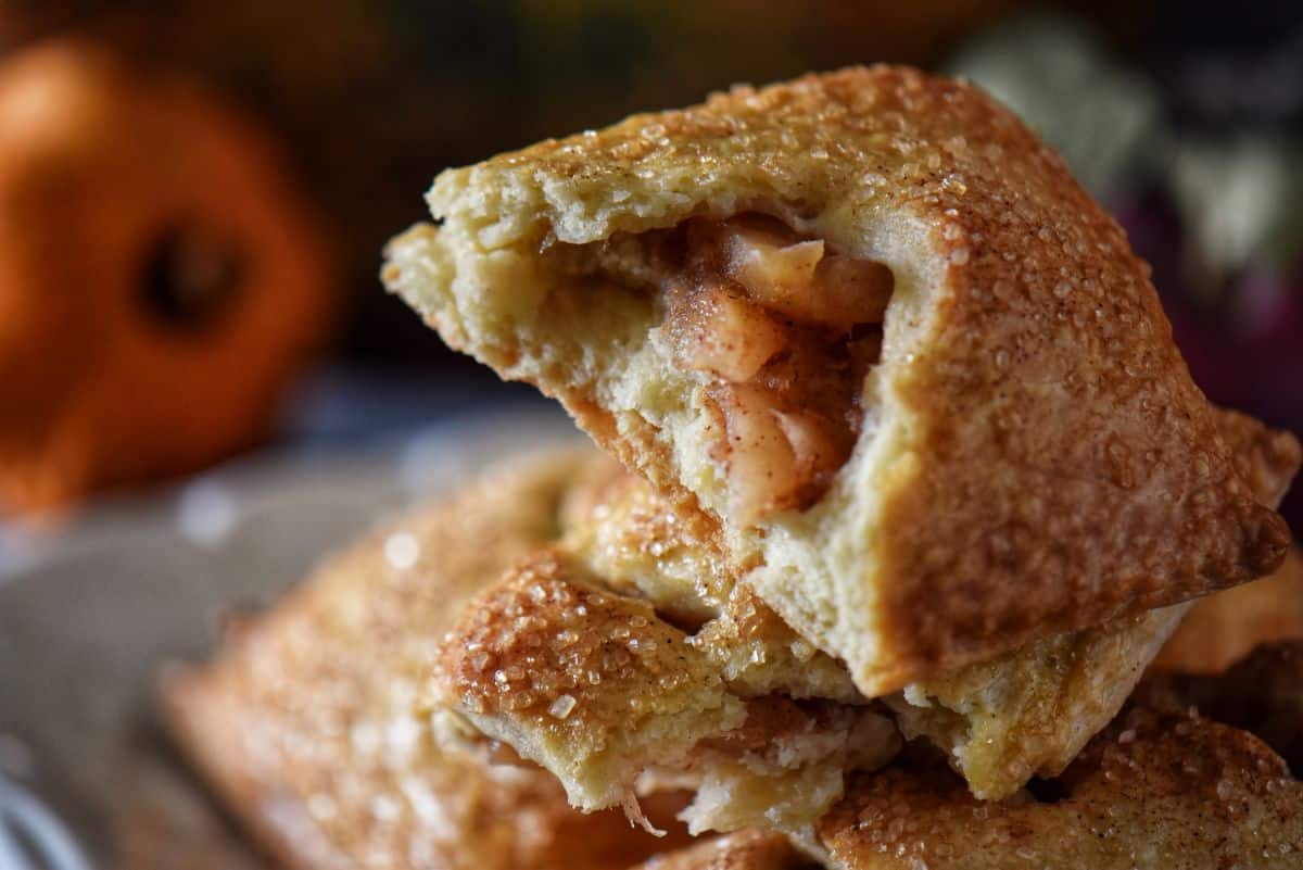 Inside view of apple hand pie with cinnamon-spiced apple filling and delicate shortcrust pastry.