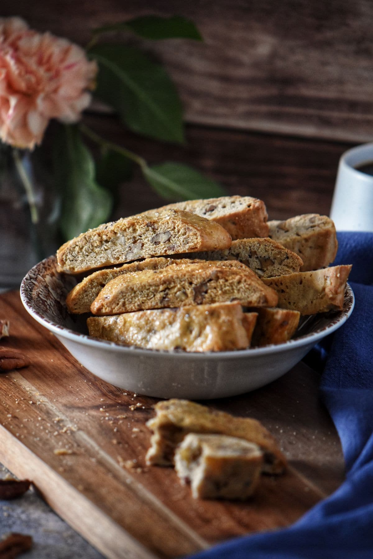 Crunchy Italian orange biscotti with pecans stacked in a bowl, ready to enjoy with coffee.