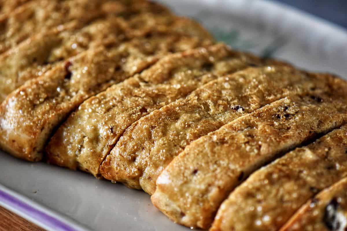 Sliced orange biscotti on a ceramic platter.