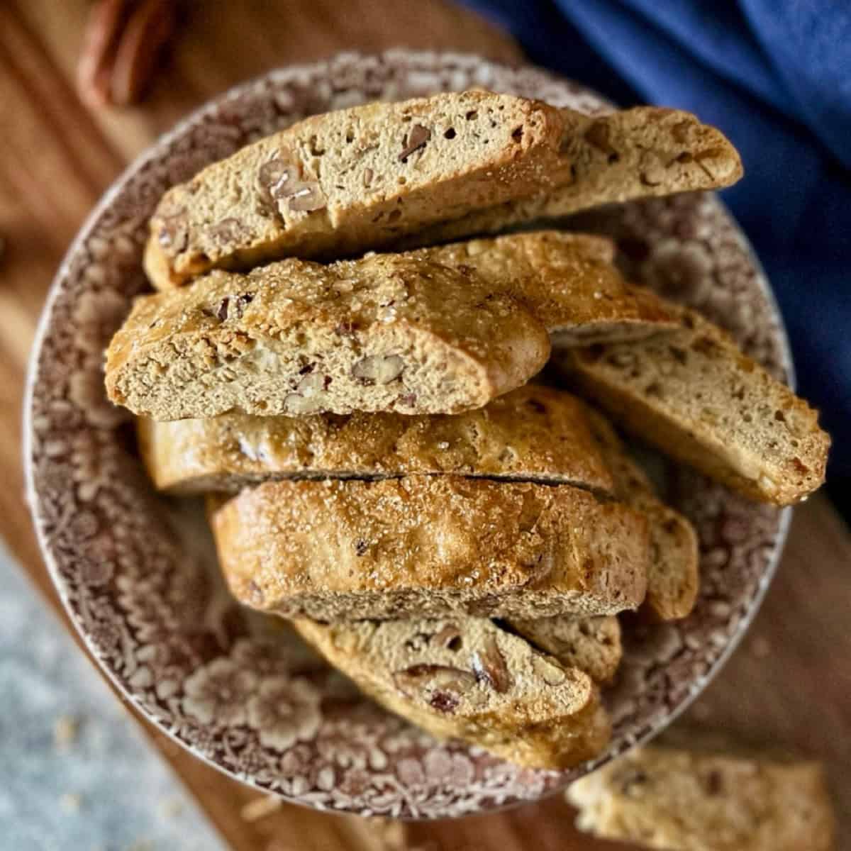 Overhead photo of orange biscotti in a bowl.