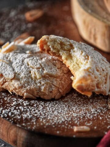Close up photo of the soft interior texture of a bitten almond paste cookie.