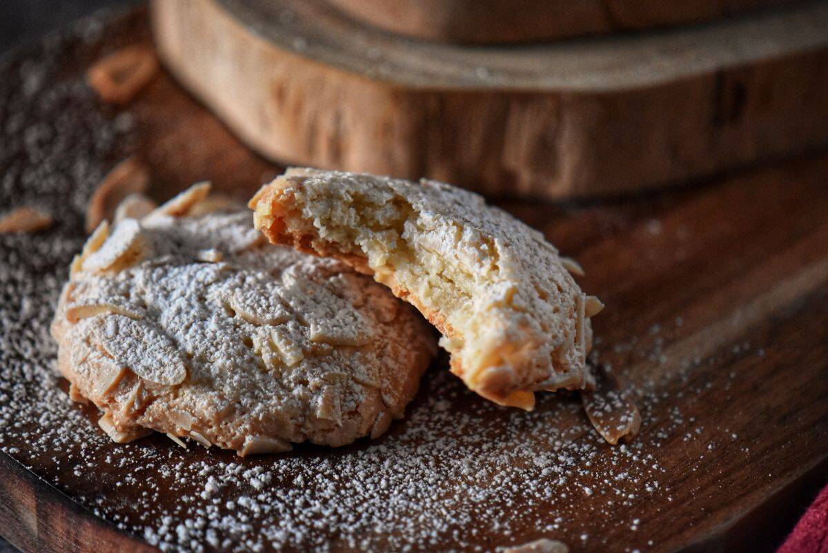 Close-up of a bitten almond paste cookie showing the soft, chewy interior texture.
