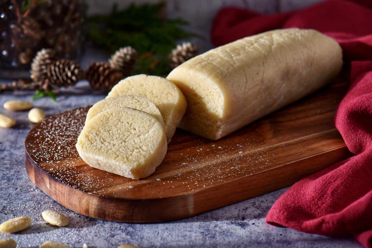 An almond paste log on a wooden board.
