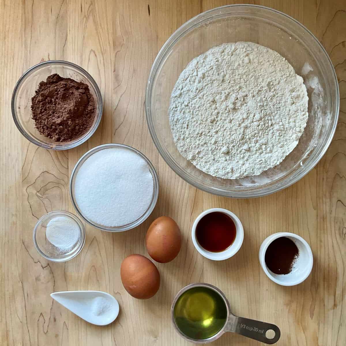 Ingredients to make Italian S cookies on a wooden table.