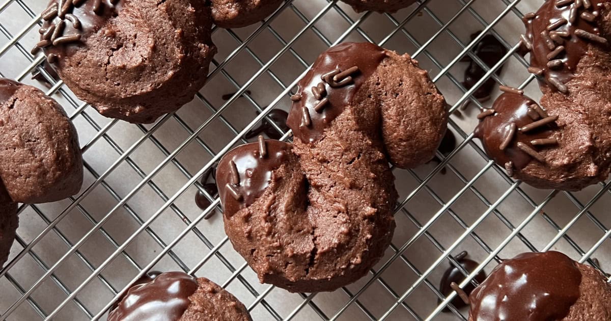 Glazed Italian chocolate cookies on a cooling rack.