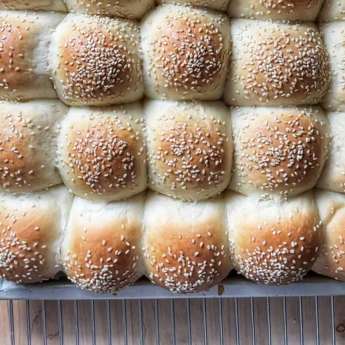 Soft Dinner Rolls on a cooling rack.