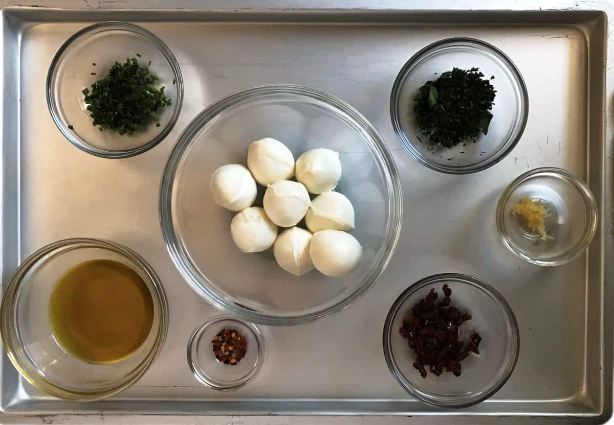 Ingredients to make marinated mozzarella balls.