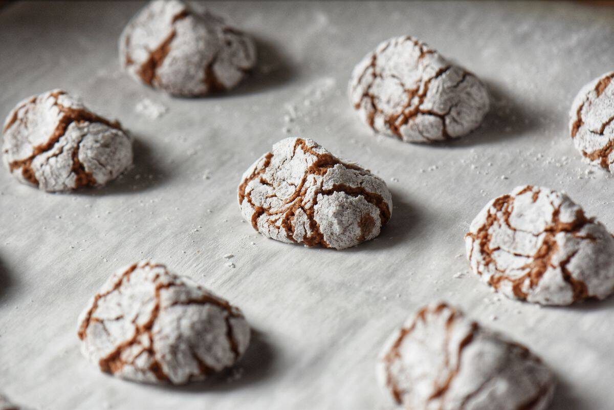 Baked chocolate amaretti cookies cooling on the parchment paper