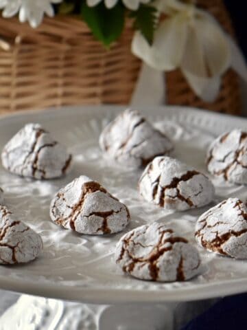 Chocolate amaretti cookies on a white platter