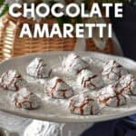 Chocolate amaretti cookies on a white platter next to a cup of espresso